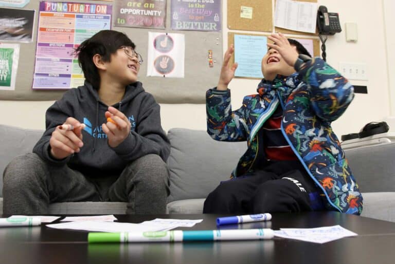 Two students laugh togehter