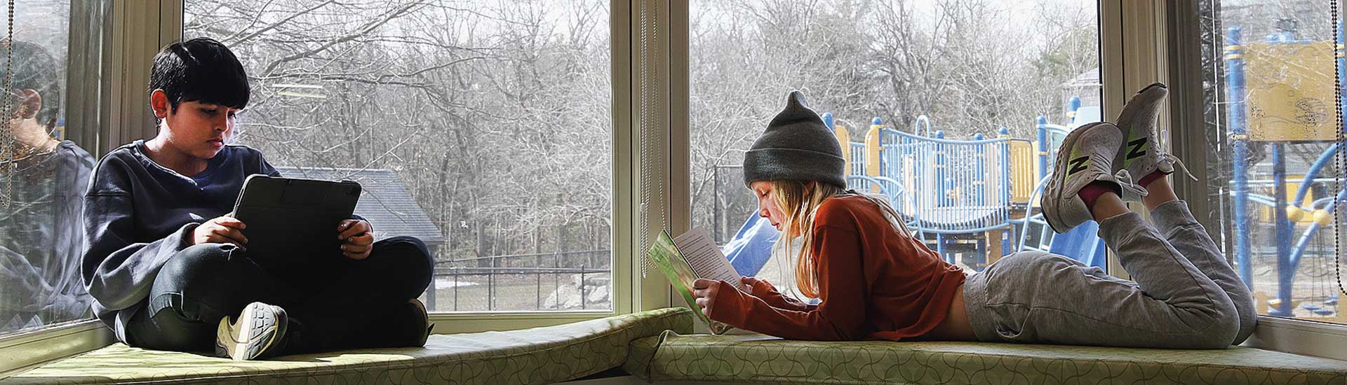 Students read in a window seat in the Erskine Library