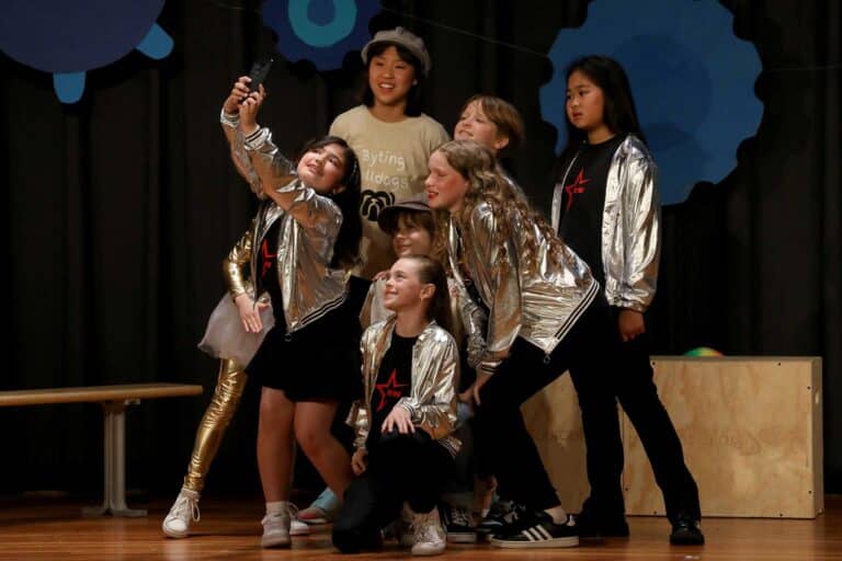 A group of students on stage performing in their class play