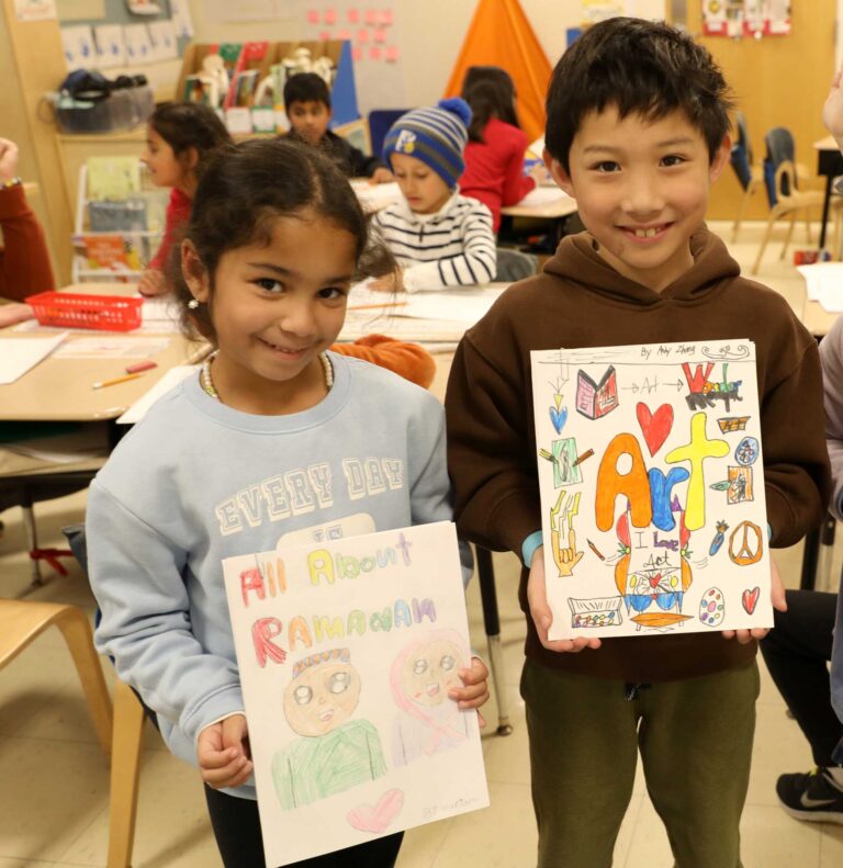 Two students display their book cover designs