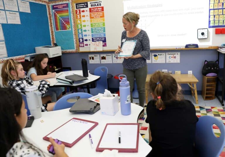 A teacher with a group in Skills and Strategies class