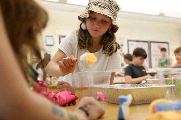 A student holds an instrument during a science activity