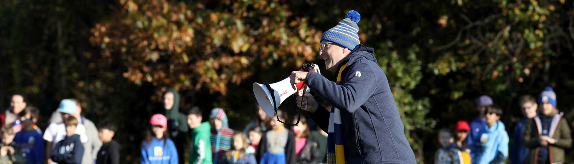Head of School Brendan Largay holds a megaphone on Spirit Day