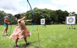 A child take aim during Archery