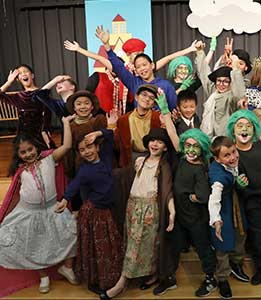 Costumed fourth graders on stage