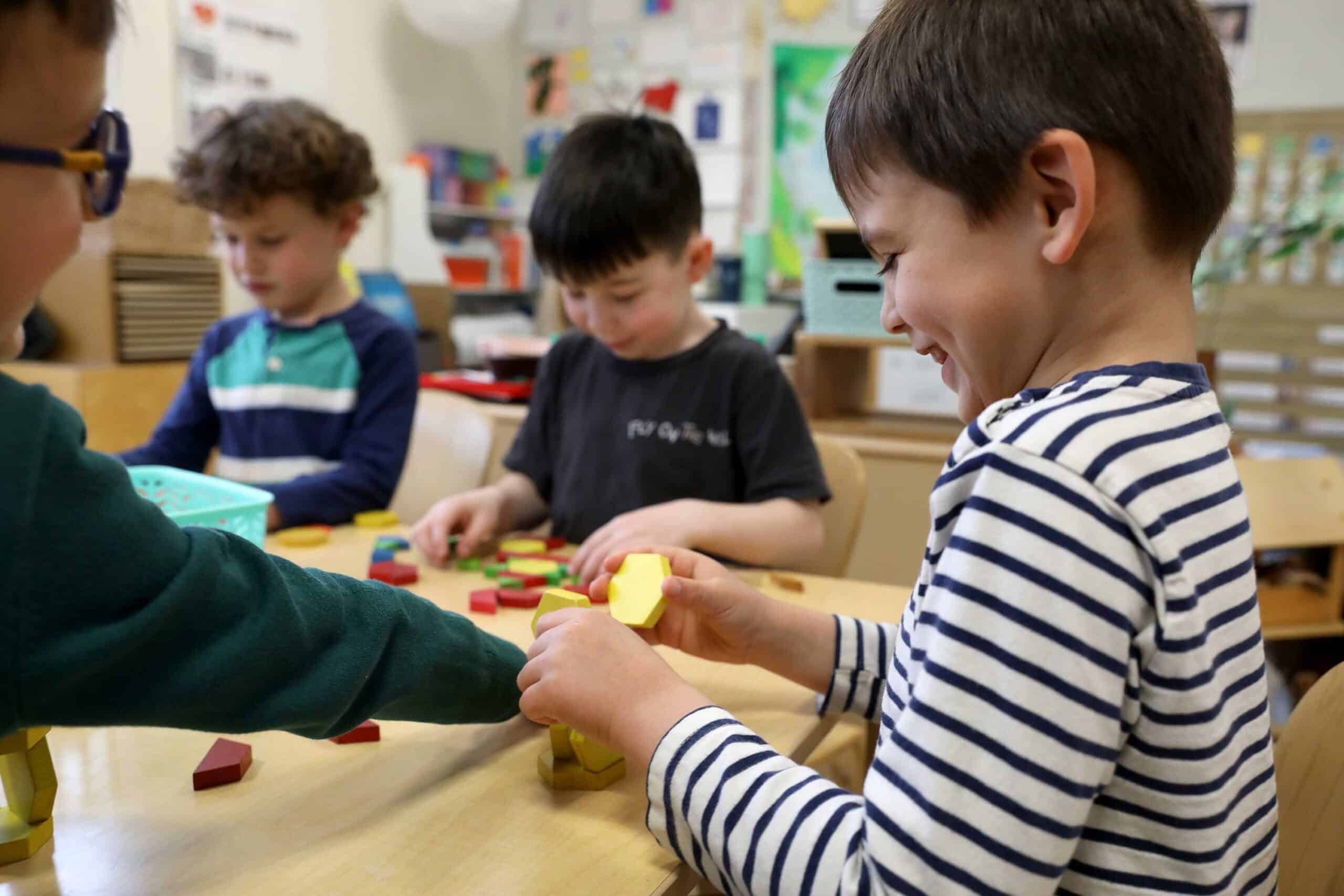 A group of four students work with math manipulatives