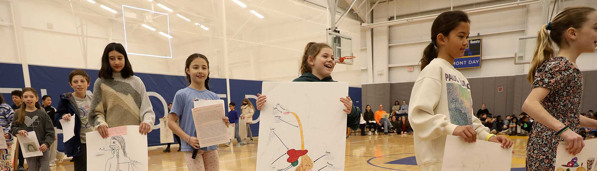 Students walking in the Barn to show their work at Sharing Assembly