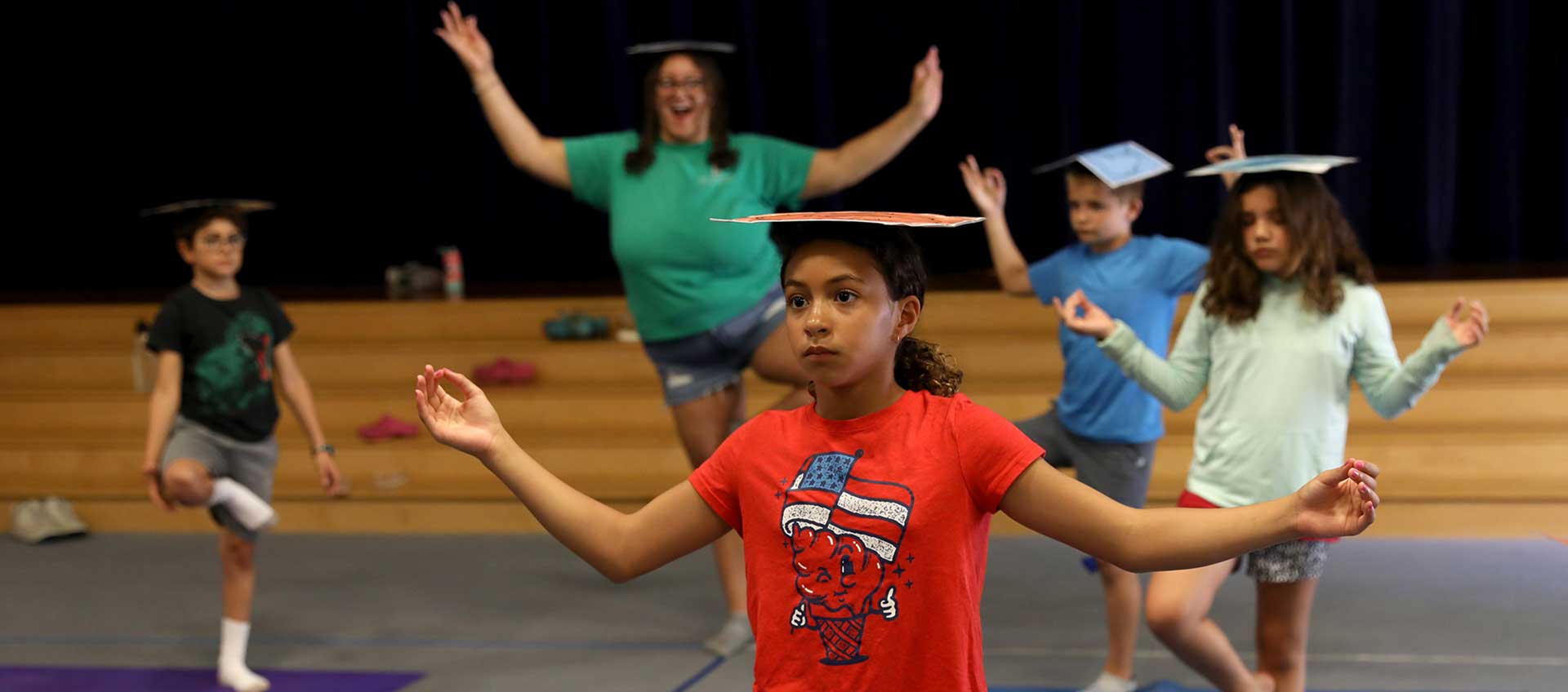 Campers practice balance and a yoga pose